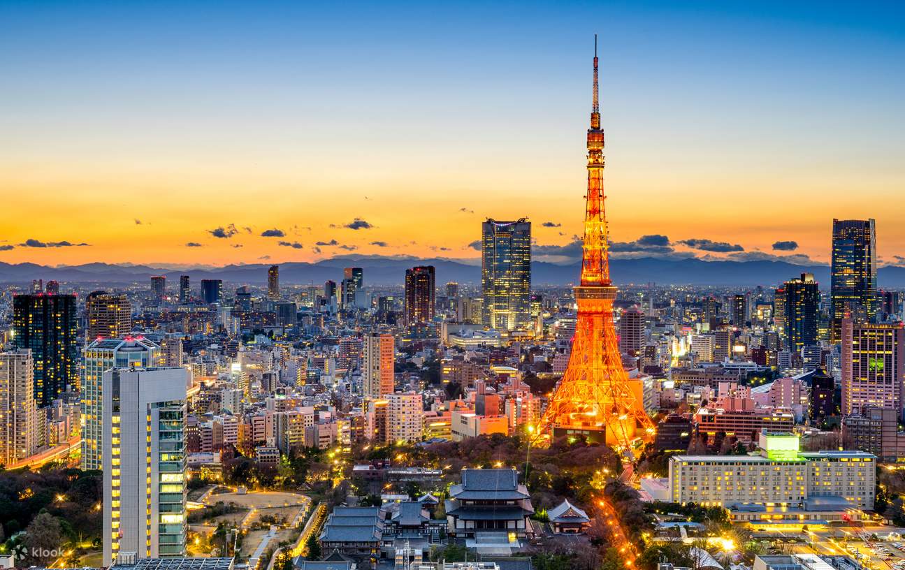 Tokyo Tower lit at dusk above the Tokyo skyline